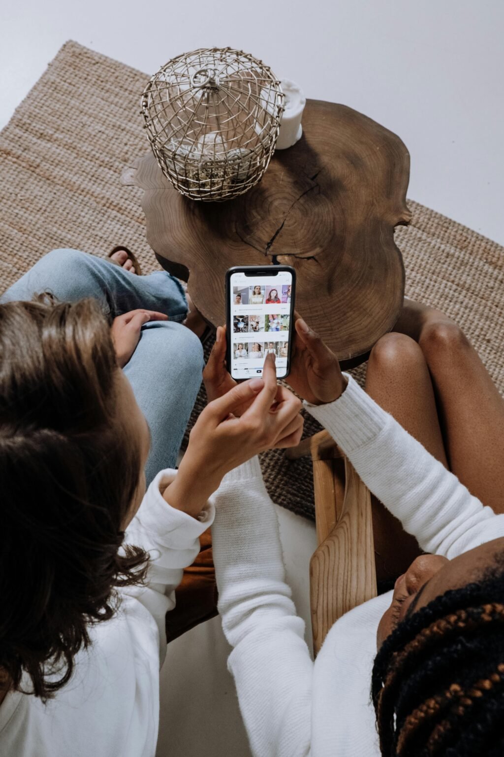 two women scrolling on a phone